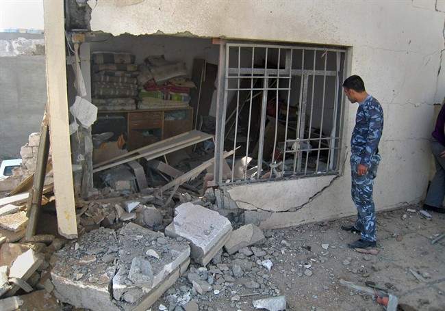 An Iraqi policeman inspects the damage to a house belonging to a lawmaker in Kirkuk, 290 kilometers (180 miles) north of Baghdad, Iraq, Thursday, May 12, 2011. An Iraqi lawmaker from the Sunni-backed Iraqiya bloc escaped an assassination attempt Thursday in the ethnically mixed city of Kirkuk. (AP Photo/Emad Matti).
