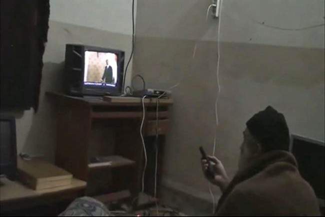 FILE - In this undated image from video seized from the walled compound of al-Qaida leader Osama bin Laden in Abbottabad, Pakistan, and released Saturday, May 7, 2011 by the U.S. Department of Defense a man, who the American government identified as Osama bin Laden, watches television, showing an image of U.S. President Barack Obama. U.S. intelligence would not confirm Saturday that the video of bin Laden in the makeshift office was filmed at the Pakistani compound, but they have said they believe he has been holed up in the compound for as long as six years. For a man on the run, Osama bin laden seemed to do very little running. Instead, he chose to spend long stretches _ possibly years _ in one place and often in the company of his family. (AP Photo/Department of Defense, File).