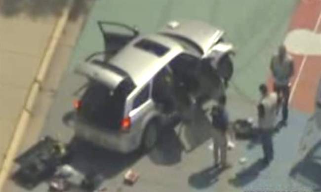 This frame grab from video courtesy KTVI Fox 2/KPLR11 shows authorities surrounding a vehicle on the Missouri University of Science and Technology campus Thursday, May 12, 2011, in Rolla, Mo. Officials say a gunman tried to break into a Missouri Army base and fired on police who pursued him before crashing a vehicle at the university, which went on lockdown after he was seen walking into a campus building. (AP Photo/courtesy KTVI Fox 2/KPLR11).