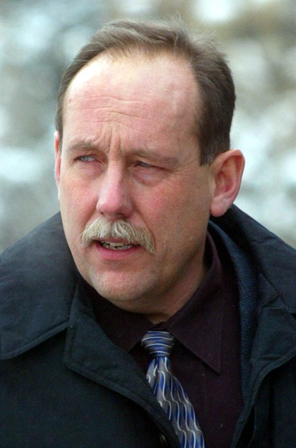 RCMP Const. Mike Ferguson arrives at the Lethbridge, Alberta, courthouse for a change in venue hearing on his second-degree murder charge, Wednesday, Jan. 28, 2004. Ferguson is charged with murdering Darren Varley in the holding cells of the Pincher Creek, Alberta, RCMP station. A report into the 1999 shooting of a prisoner in an Alberta RCMP holding cell is recommending the force be more prompt in investigating complaints about the behaviour of officers. THE CANADIAN PRESS/Jeff McIntosh.