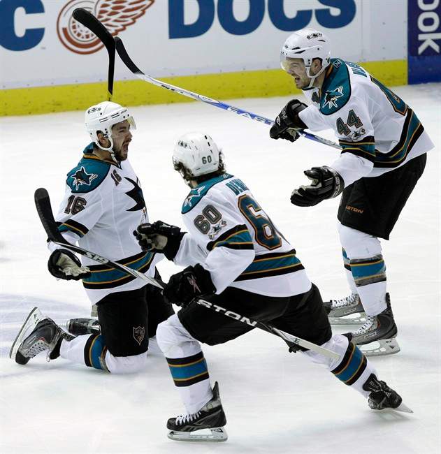 San Jose Sharks forward Devin Setoguchi celebrates scoring the game winning goal in overtime against the Detroit Red Wings with Marc-Edouard Vlasic (44) and Jason Demers (6) in Game 3 of a second-round NHL Stanley Cup playoff hockey series in Detroit, Wednesday, May 4, 2011. San Jose won 4-3 to take a 3-0 lead in the series. (AP Photo/Paul Sancya).