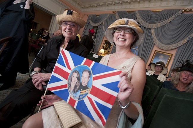 Mardi Cockburn, left, and Margo Flewelling hold up a flag showing the Royal coouple at Old Government House in Fredericton, NB on Friday, April 29, 2011. Old Government House, the official residence of Lt. Gov. Graydon Nicholas, was open to the public so that fans of the Royal Family could watch the wedding ceremony of Will and Kate together. THE CANADIAN PRESS/ David Smith.
