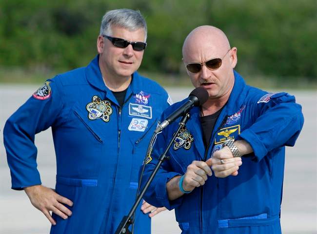 Space shuttle Endeavour commander Mark Kelly, right, looks at his watch, with British born U.S. astronaut, pilot Greg Johnson, left, after arriving at the Kennedy Space Center in Cape Canaveral, Fla., Thursday, May 12, 2011. Kelly announced to members of the media that on Monday, May 16 at a little after 9 a.m., they expect to be on their way to the International Space Station. (AP Photo/John Raoux).