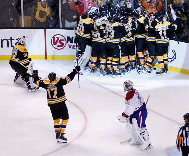 Montreal Canadiens goalie Carey Price, bottom right, skates off the ice as the Boston Bruins surround Nathan Horton after he scored the game-winning goal during the second overtime period in Game 5 of a first-round NHL Stanley Cup hockey playoff series in Boston, Saturday, April 23, 2011. The Bruins won 3-2 and take a 3-2 lead in the series. (AP Photo/Charles Krupa).