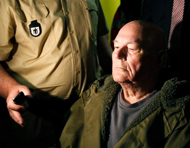 John Demjanjuk leaves the court room in Munich, southern Germany, on Thursday, May 12, 2011. The court has ordered John Demjanjuk released pending an appeal of his conviction as an accessory to murder at a Nazi death camp. (AP Photo/Matthias Schrader).