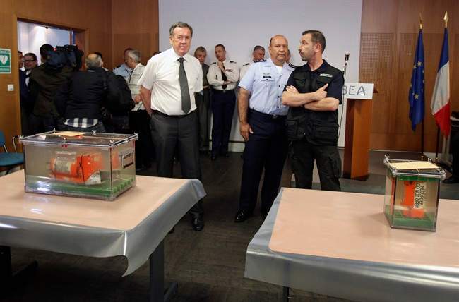 Jean-Paul Troadec, head of technical investigations into civil aviation accidents, left, his Brazilian counterpart Luis Lupoli, center, and French police officer Patrice Grenouillat, right, stands next to the two flight recorders of the Air France flight 447, which crashed in 2009, are displayed to reporters during a press conference at the French investigators' headquarters in Le Bourget, near Paris, Thursday, May 12, 2011. Two flight recorders that could unravel the cause of an Air France crash almost two years ago have arrived at French investigators' headquarters in a high security operation. The next step is to determine if the flight data recorder and cockpit voice recorder survived the crash and the ocean depths where they were discovered. (AP Photo/Michel Euler).
