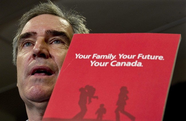 Liberal Leader Michael Ignatieff shows the party platform as he responds to a question during a news conference Monday, April 25, 2011 in Thunder Bay, Ont. THE CANADIAN PRESS/Paul Chiasson.