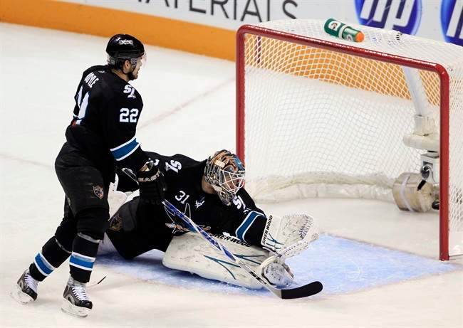 San Jose Sharks goalie Antti Niemi, of Finland, center, is beating for a goal on a shot from Detroit Red Wings defenseman Nicklas Lidstrom, of Sweden, during the first period in Game 1 of an NHL Western Conference semifinal Stanley Cup playoff hockey series game in San Jose, Calif., Friday, April 29, 2011. (AP Photo/Paul Sakuma).