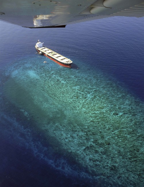 In this aerial photo provided by the Sarangani Information Office, the Panamanian-registered ship MV Double Prosperity remains stuck at Bakud Reef Thursday, May 12, 2011 after running aground Sunday, May 8 more than 2 miles (4 kilometers) off Sarangani province in southern Philippines. Officials say the ship loaded with coal has run aground and destroyed a large portion of a marine sanctuary in Sarangani Bay. (AP Photo/Sarangani Information Office, Cocoy Sexcion) NO SALES EDITORIAL USE ONLY.