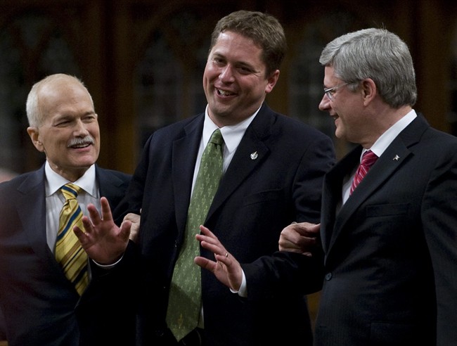 Speaker of the House of Commons Andrew Scheer jokingly tries to fight with Prime Minister Stephen Harper and NDP leader Jack Layton as they escort him to the Speakers chair in the House of Commons on Parliament Hill in Ottawa, Thursday June 2, 2011. THE CANADIAN PRESS/Adrian Wyld.