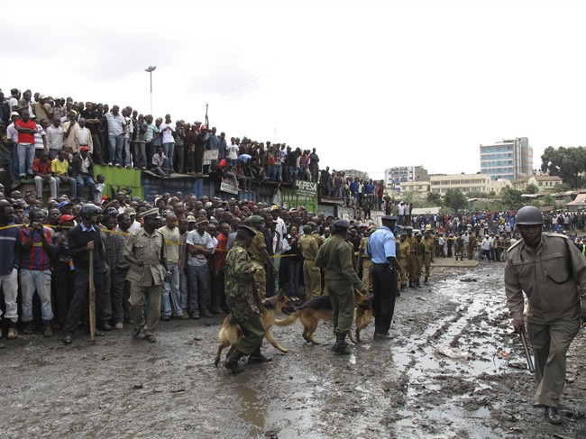 Police use dogs to control the crowd after an explosion in a highly populated area in Nairobi, Kenya, Sunday, June 5, 2011. Police say an explosion in a highly populated area of Nairobi has injured at least 15 people. Director of police operations, Julius Ndegwa, says it appears no one was killed in Sunday's blast in Kenya's capital. He says it is too early to tell if it was terrorism related.(AP Photo/Sayyid Azim).