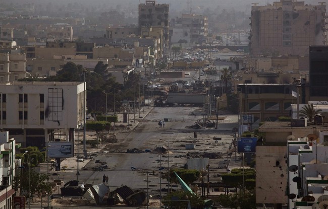 In this photo taken Sunday, May 22, 2011, a general view of Tripoli street from the terrace of a building used by snipers loyal to Libyan leader Moammar Gadhafi during fighting with rebels in downtown Misrata, Libya. Since the weeks-long siege of the city ended in mid-May, Misrata residents make pilgrimages to Tripoli Street, site of the fiercest fighting in the battle for Libya between the rebels and Moammar Gadhafi's forces. People gawk at the wreckage of bombed-out buildings with gaping holes and walls pocked by bullets, and shoot photos of charred hulks of tanks, rubble-strewn streets and a side walk museum featuring drumloads of bullet casings, uniforms of dead enemies, and unexploded munitions. (AP Photo/Rodrigo Abd).