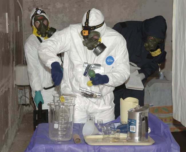 FILE--Health officials investigate a scene, collect samples, and measure forensic evidence for radioactive contamination durign a radiation detection exercise in this 2006 handout photo. THE CANADIAN PRESS/HO -Defence R&D Canada.