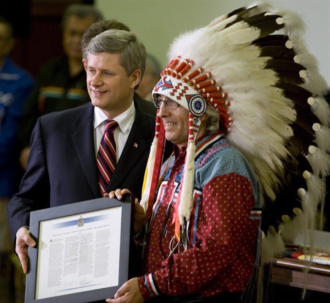 Assembly of First Nations Chief Phil Fontaine is presented with a citation by Prime Minister Stephen Harper, left, in the House of Commons on Parliament Hill in Ottawa, on June 11, 2008. An agenda for a First Nations summit with the prime minister is beginning to take on solid form, Friday June 3, 2011. THE CANADIAN PRESS/Fred Chartrand.