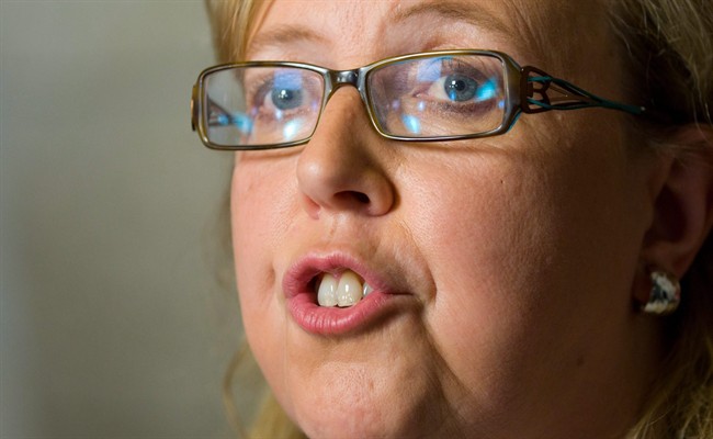 Green Party Leader Elizabeth May reacts to the federal budget as he speaks to reporters in the foyer of the House of Common on Parliament Hill in Ottawa on Monday, June 6, 2011. May says the Harper government is gutting its ability to deal with climate change by laying off key researchers at Environment Canada. THE CANADIAN PRESS/Adrian Wyld.