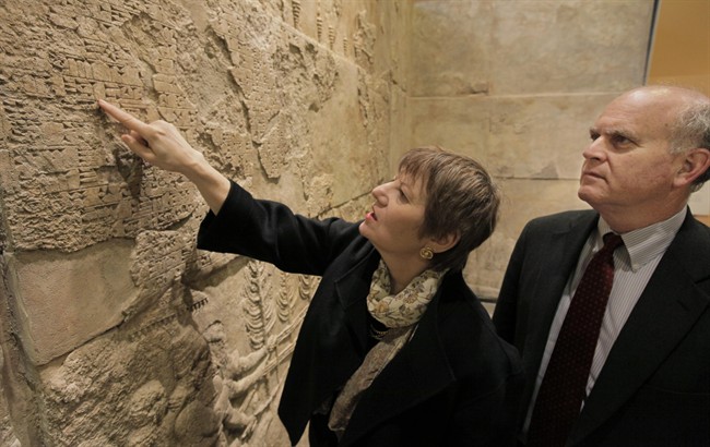 ** ADVANCE FOR USE MONDAY, JUNE 6, 2011 AND THEREAFTER ** In this May 27, 2011 photo, Martha Roth, dean of humanities at the University of Chicago, and Gil Stein, director of the Oriental Institute at the university, examine reliefs from the palace of Sargon II (721-705 BC in the Assyrian capital city of Khorsabad, in northern Iraq) in one of the institute's galleries in Chicago. Roth is the editor-in-charge of a project started 90 years ago by the institute to assemble an Assyrian dictionary based on words recorded on tablets unearthed in Iraq, Iran, Syria, and Turkey, and written in a language that hadn't been uttered for more that 2,000 years. The massive 21-volume collection is now complete. (AP Photo/M. Spencer Green).