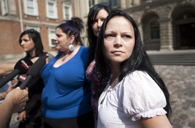 Timea Nagy, right, a former sex slave and victim of human trafficking, joins other former sex workers and activists against the legalization of prostitution while speaking to reporters outside a Toronto court in 2011.