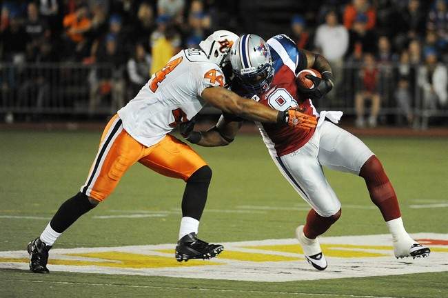 B.C. Lions' Adam Leonard (44) tackles Montreal Alouettes' Kerry Carter (8) during second half CFL football action in Montreal, Thursday, June 30, 2011.THE CANADIAN PRESS/Graham Hughes.