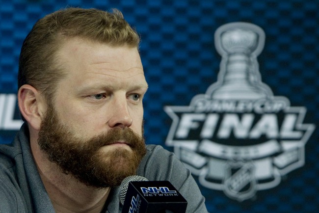 Boston Bruins goaltender Tim Thomas pauses for a moment as he listens to a question during a media availability in Boston, Mass., Sunday, June 5, 2011. The Boston Bruins will play the Vancouver Canucks in game 3 of the NHL Stanley Cup hockey finals in Boston, Monday, the Canucks lead the series 2-0. THE CANADIAN PRESS/Jonathan Hayward.