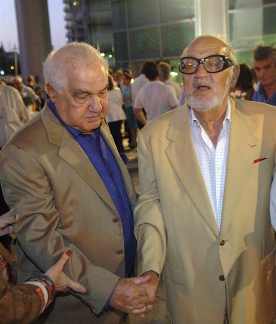 FILE - In this Aug. 28, 2007 photo Israeli business tycoons Yuli Ofer, left, and his brother Sammy Ofer, right, attend a cornerstone laying ceremony for a medical center they donated the money for at a Tel Aviv hospital. Sammy Ofer, an Israeli businessman at the center of a recent scandal involving trade with Iran, has died at age 89. Israeli media reported that billionaire Sammy Ofer died Friday after a long illness. (AP Photo/Moti Kimhi, Haaretz) ISRAEL OUT.