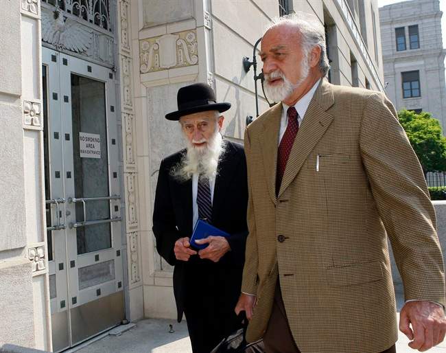 Rabbi Saul Kassin, left, arrives at Clarkson S. Fisher federal building and United States courthouse Wednesday, June 1, 2011 in Trenton, N.J., for sentencing in his admitted role in a money laundering scheme. Kassin, leader of the Syrian Jews in the United States, was one of five rabbis and 46 total defendants arrested in 2009 in a massive federal probe into money laundering and corruption in New Jersey. (AP Photo/Mel Evans).