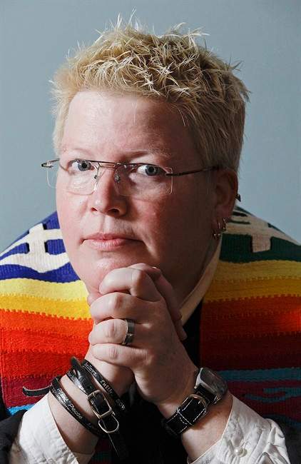FILE - In this June 16, 2011 file photo, Rev. Amy DeLong sits at her home, in Osceola, Wis. The Methodist pastor on Wednesday, June 22, 2011, was found guilty in a church trial of marrying a lesbian couple in 2009. The jury found the 44-year-old not guilty of a second charge of being a "self-avowed practicing homosexual." (AP Photo/Stacy Bengs, File).