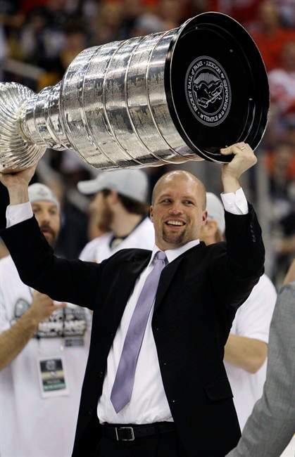 In this June 12, 2009, photo, Pittsburgh Penguins assistant coach Mike Yeo raises the Stanley Cup after the Penguins beat the Detroit Red Wings 2-1 to win Game 7 of the NHL hockey Stanley Cup finals in Detroit. The Minnesota Wild have made Yeo their new coach, according to a person with knowledge of the decision. The person spoke to The Associated Press Thursday, June 16, 2011, on condition of anonymity because the team had not announced the hire. The Wild called a Friday news conference at Xcel Energy Center in St. Paul, their home arena. Twin Cities radio station KFAN-AM first reported Yeo's hire. (AP Photo/Paul Sancya).