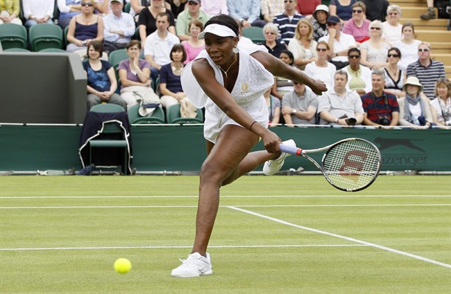 Venus Williams of the US in action against Uzbekistan's Akgul Amanmuradova at the All England Lawn Tennis Championships at Wimbledon, Monday, June 20, 2011. (AP Photo/Kirsty Wigglesworth).