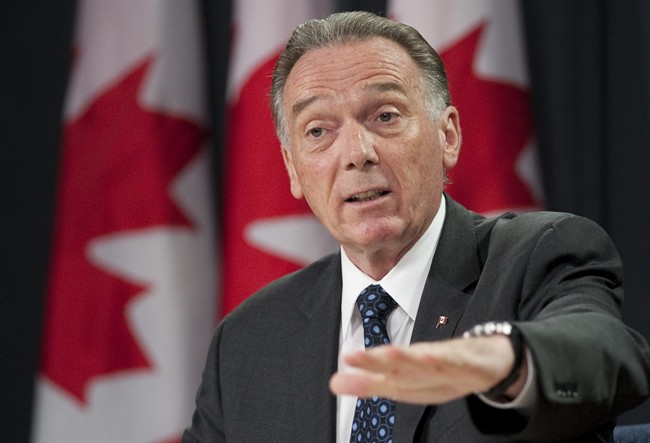 Minister of the Environment Peter Kent announces plans for integrated oil sands monitoring during a news conference in Ottawa, Thursday July 21, 2011. THE CANADIAN PRESS/Adrian Wyld.