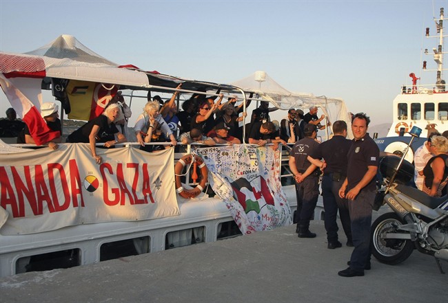 Passengers are seen on the deck of a boat, shortly after the boat was returned to the port by the coast guard in Agiios Nikolaos, northeastern Crete, Greece on Monday, July 4, 2011. A boat taking part in a flotilla seeking to break Israel's Gaza Strip sea blockade tried to leave the southern island of Crete Monday but was turned back by Greek forces, as the Athens government warned that lives could be lost if the mission goes forward. The coast guard stopped the boat shortly after it set sail without permission from the port of Agios Nikolaos in northeastern Crete, and towed it back into port(AP Photo/Image Photo Services).