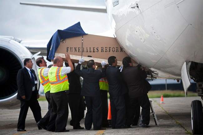 Funeral workers load into an airplane heading to Argentina, a coffin containing the body of murdered Argentine folk singer Facundo Cabral in Guatemala City, Monday, July 11, 2011. One of Latin America's most admired folk singers, Facundo Cabral, was killed Saturday July 9 when three cars loaded with gunmen ambushed the vehicle in which he was riding, prompting expressions of anguish from across the region. Authorities said the performer's concert promoter who was traveling with Cabral was apparently the target. (AP Photo/Rodrigo Abd).