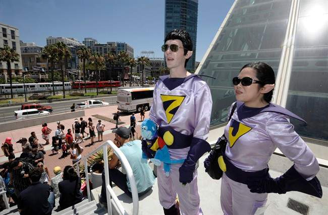 Power Twins Douglas McCullough and Katherine Napalinga look over the scene as they arrive a at Comic-Con International 2011 convention held in San Diego Saturday, July 23, 2011. The annual comic book and popular arts convention attracts over 100,000 people and runs through Sunday July 24. (AP Photo/Denis Poroy).