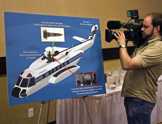 A cameraman records a display at a Transportation Safety Board of Canada news conference releasing the final report into the fatal 2009 crash of Cougar Flight 91, in St. John’s, N.L. on Wednesday, Feb. 9, 2011. The U.S. aviation regulator says it won’t require the retrofit of a gearbox blamed in a fatal helicopter crash off Newfoundland because it would be too expensive for the industry. THE CANADIAN PRESS/Andrew Vaughan