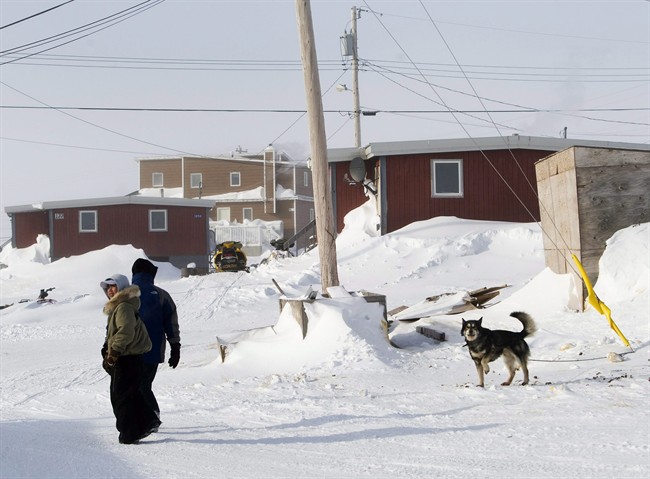 Inuit people make their way through the snow-filled streets of Baker Lake in Nunavut on Wednesday, March 25, 2009.