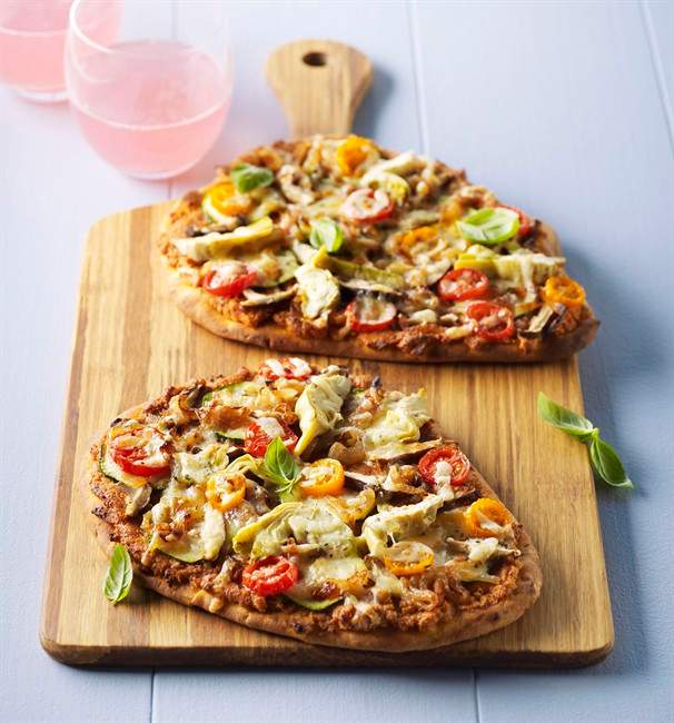 Naan Bread Pizza. These vegetarian grilled naan bread pizzas have a delicious twist. Walnuts, Parmesan cheese and sun-dried tomatoes serve as a base for a topping of fresh vegetables. THE CANADIAN PRESS/ HO.