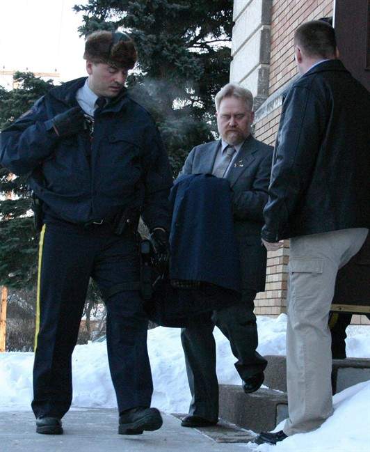 Kim Walker is lead from court by RCMP officers in Yorkton, Sask. on Friday Jan. 19, 2007. Saskatchewan man who argued he shot his daughter's boyfriend to save her from a life of drugs will spend another year and a half behind bars. THE CANADIAN PRESS/Karl Kopan.