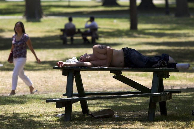 A man sleeps on a picnic table in Toronto's Queen's Park as temperatures hit a high of 41C with the humidex during a heatwave in 2011.