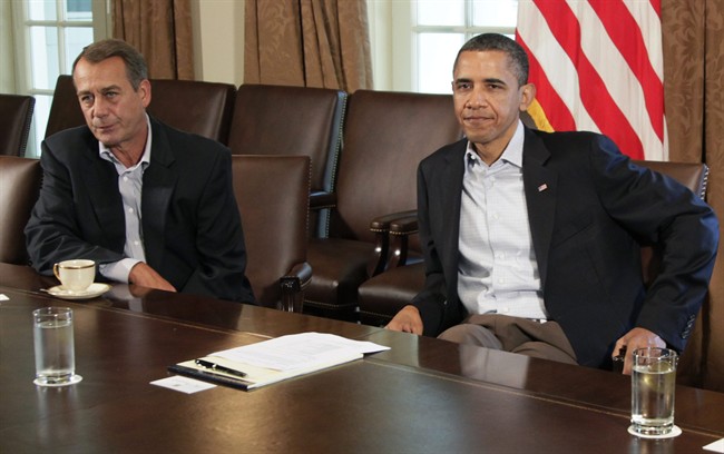 President Barack Obama sits next to House Speaker John Boehner of Ohio, left, in the Cabinet Room of the White House, Saturday, July 23, 2011, in Washington, as they meet to discuss the debt. (AP Photo/Carolyn Kaster).