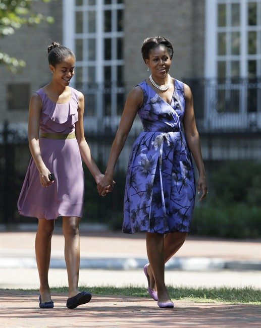 First lady Michelle Obama walks with her daughter Malia Obama walk from St. John's Church, through Lafayette Park and back to the White House, after attending church services, Sunday, July 17, 2011, in Washington. (AP Photo/Carolyn Kaster).