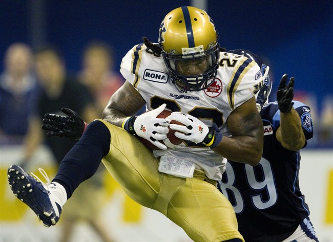 Jonathan Hefney makes an interception against Toronto Argonauts wide receiver Spencer Watt during a CFL game in Toronto in July 2011.
