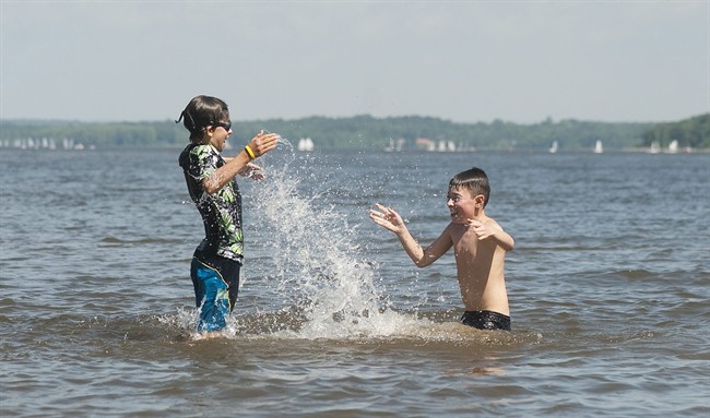 Evan Buddle, 11, and Christopher Mailloux, 10, cool down in the Lake of Two Mountains west of Montreal, Friday, July 22, 2011 as temperatures remain in the high 30s and a heat wave warning is still in effect. THE CANADIAN PRESS/ Graham Hughes.