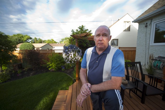 RCMP Cpl. Gerry Hoyland is shown in his yard in Edmonton, on Friday, July 15, 2011. Hoyland has waited over five years for vindication and, given the RCMP's track record, he expects to bide his time for a few more. THE CANADIAN PRESS/John Ulan.
