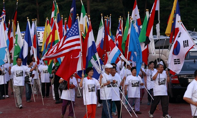 South Korean supporters march with flags of all nations to support for Pyeongchang's bid to host the 2018 Winter Games, in Pyeongchang, South Korea, Wednesday, July 6, 2011. The International Olympic Committee will vote by secret ballot Wednesday, choosing from among the Korean resort of Pyeongchang, the Bavarian capital of Munich and the French lakeside town of Annecy. (AP Photo/Lee Jin-man).