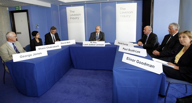 Lord Justice Leveson, centre, and the assessors of his inquiry into culture practices and ethics of the press, from left, George Jones, Shami Chakrabarti, David Bell, David Currie, Paul Scott-Lee and Elinor Goodman, attend the openiong of the inquiry in London, Thursday July 28, 2011. Justice Brian Leveson said he has the legal power to demand evidence from witnesses - and plans to use it "as soon as possible." The inquiry was announced earlier this month by Prime Minister David Cameron in the wake of a scandal over illegal eavesdropping that has closed down the 168-year-old News of the World tabloid and shaken Rupert Murdoch's global media empire. Leveson's 7-member panel includes a veteran newspaper reporter, a former police chief, a civil liberties activist and a broadcast journalist, and they will begin public hearings in September. (AP Photo/Sean Dempsey, pool).