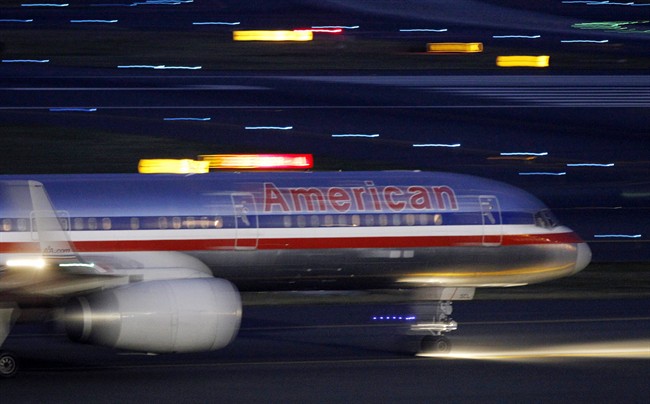 An American Airlines jet taxis on a runway as it takes off at Logan International Airport in Boston Tuesday, July 19, 2011.