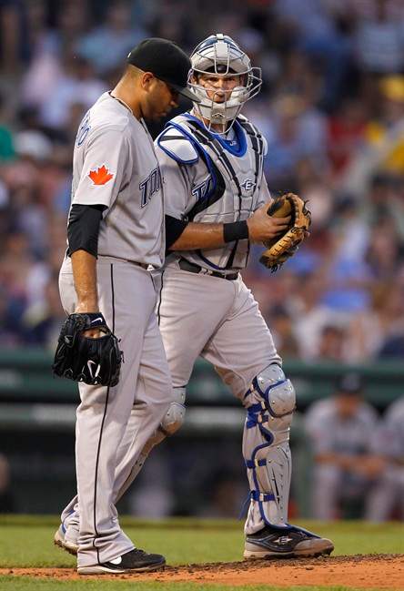 Toronto Blue Jays pitcher Ricky Romero, left, talks with catcher J.P. Arencibia, after giving up a double hit to Boston Red Sox's J.D. Drew during the fourth inning of a baseball game at Fenway Park, Wednesday, July 6, 2011, in Boston. (AP Photo/Steven Senne).