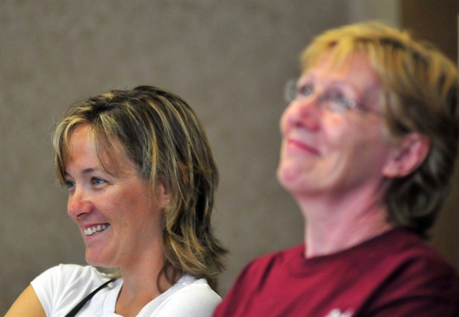 Michael W. Trapp's wife Julie Trapp, left, and his mother Jill Trapp listen as Michael W. Trapp, describes his ordeal during a news conference at Covenant HealthCare Cooper Campus in Saginaw, Mich. on Thursday, July 28, 2011. Trapp's plane crashed Tuesday evening near Harbor Beach, about 105 miles north of Detroit. He treaded water and swam without a life jacket for 18 hours after his small plane crashed into Lake Huron said a number of boats passed him by but couldn't hear his cries for help. Dean and Diane Petitpren from Grosse Pointe Farms near Detroit saw him waving a sock in the water and hauled him aboard their yacht about on Wednesday. (AP Photo/The Saginaw News, Jeff Schrier).