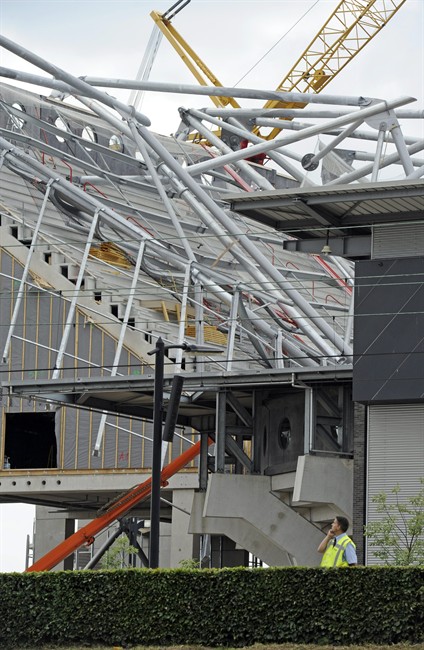 A view of the collapsed stadium in Enschede, Netherlands, Thursday, July 7, 2011. A section of a Dutch football stadium collapsed during off-season construction work Thursday, trapping people underneath, police said. No match was being played at the FC Twente stadium at the time of the collapse and those trapped were believed to be workers. Local newspaper De Twentsche Courant, citing unnamed workers at the stadium, reported on its website that 12 people were injured in the accident. (AP Photo/Martin Meissner).