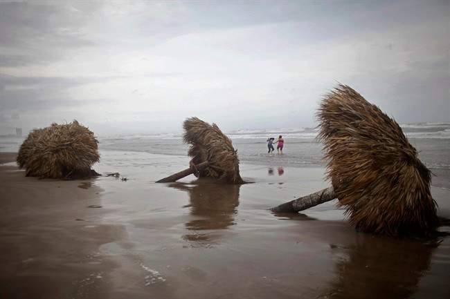 People have fun at "Playa Azul" or "Blue beach," after the passage of the Tropical Storm Arlene in Tuxpan, Mexico, Thursday, June 30, 2011. The Atlantic season's first tropical storm hit Mexico's central Gulf coast Thursday, hurling heavy rains over a wide swath of the country but causing little damage. (AP Photo/Alexandre Meneghini).