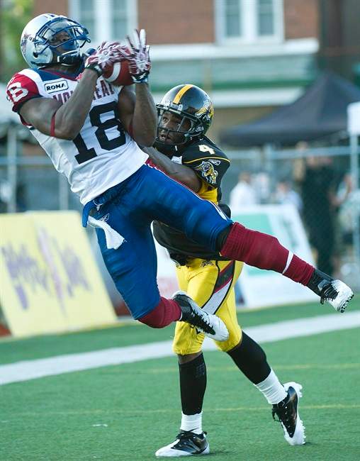 Montreal Alouettes wide receiver Jamel Richardson, left, makes a touch down catch past Hamilton Tiger-Cats defensive back Carlos Thomas, right, during first half CFL football action in Hamilton, Ont., on Friday, July 29, 2011. THE CANADIAN PRESS/Nathan Denette.